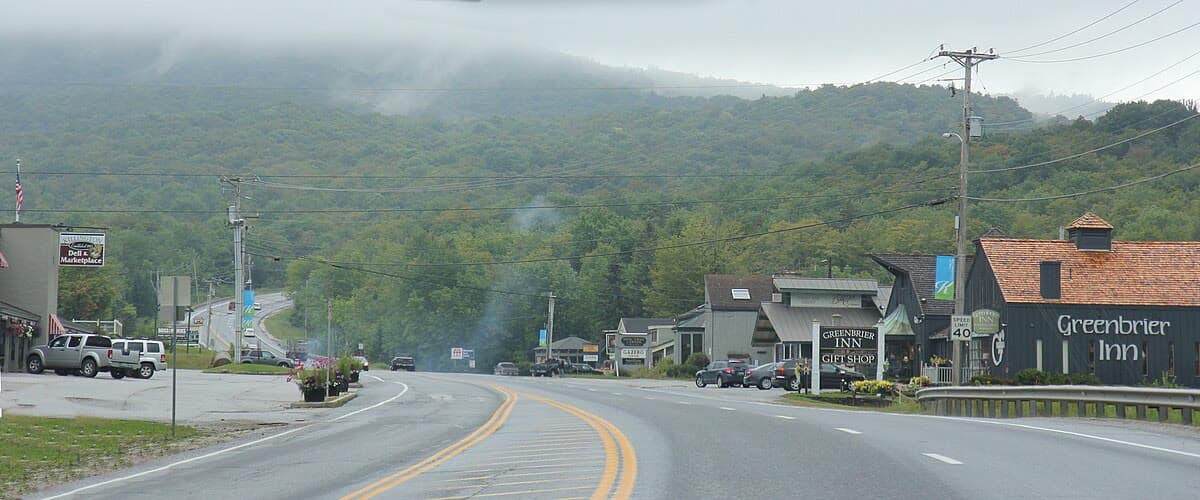 Route 4 corridor near Killington, Vermont, with local businesses and fog-draped Green Mountains in the background