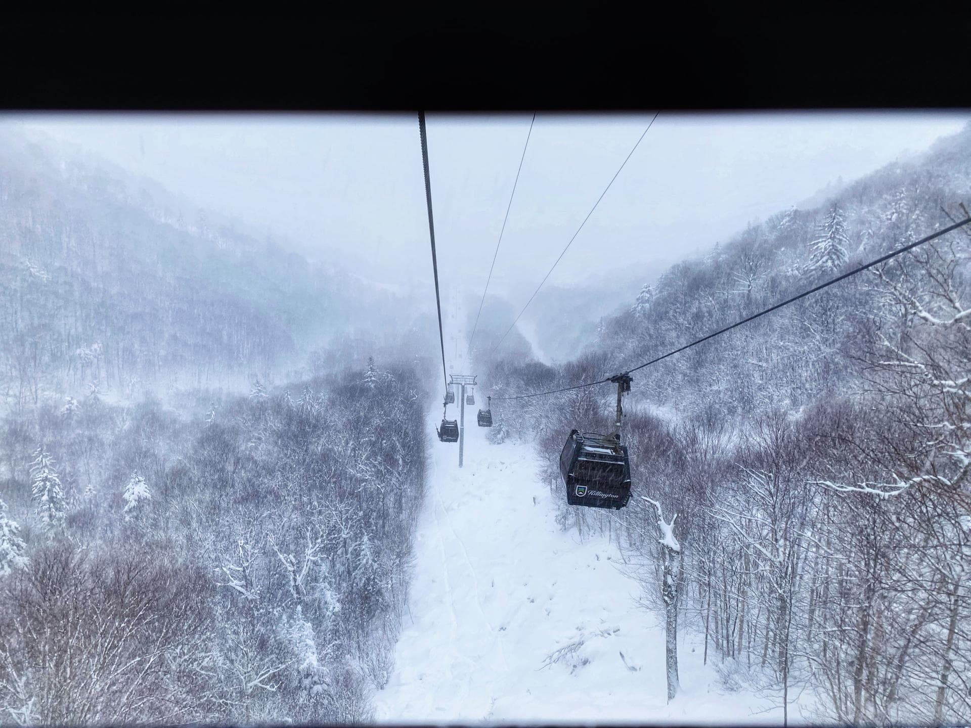 Killington ski resort gondola ascending snow-covered mountain slopes in winter